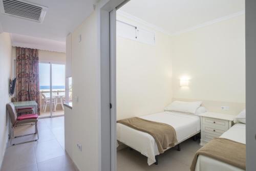 a bedroom with two beds and a view of the ocean at Marina view modern apartment in Fuengirola