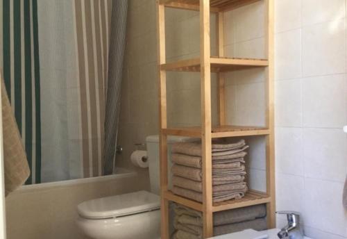 a bathroom with a toilet and a rack of towels at Great view in Riviera del Sol in Sitio de Calahonda