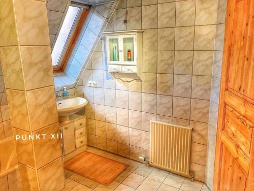 a small bathroom with a sink and a shower at Wohnung 2 in Burghaslach