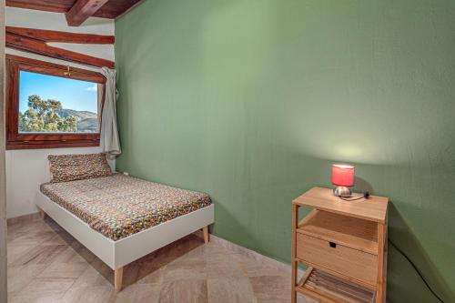 a bedroom with a bed and a table with a lamp at Residence Orizzonti 33 in Golfo Aranci