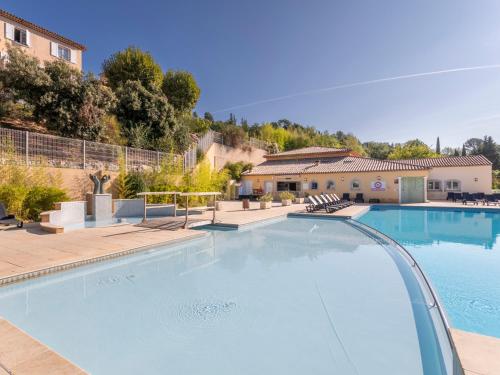 a large swimming pool in the middle of a house at Vacancéole – Le Domaine de Camiole in Callian