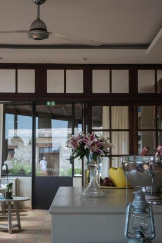 a vase of flowers on a counter in a kitchen at Auberge De Tourrettes in Tourrettes-sur-Loup