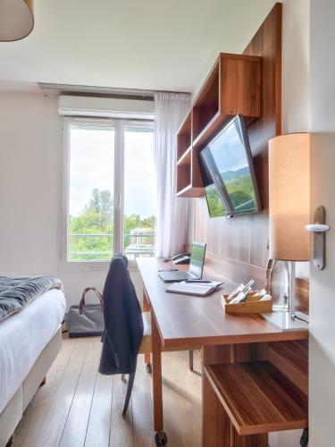 a bedroom with a desk with a laptop on it at Residhome Paris Saclay " Bures sur Yvette " in Bures-sur-Yvette