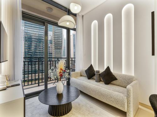 a living room with a couch and a table at Luxurious Escape - ZADA TOWER - Close to Dubai Mall & Burj Khalifa in Dubai