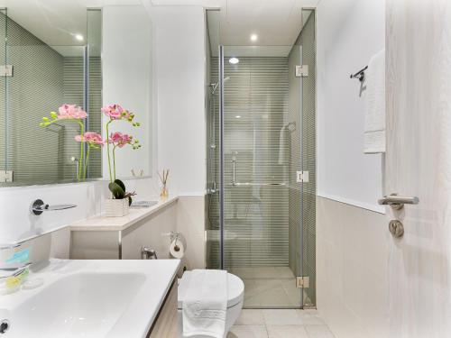 a bathroom with a shower and a toilet and a sink at Luxurious Escape - ZADA TOWER - Close to Dubai Mall & Burj Khalifa in Dubai