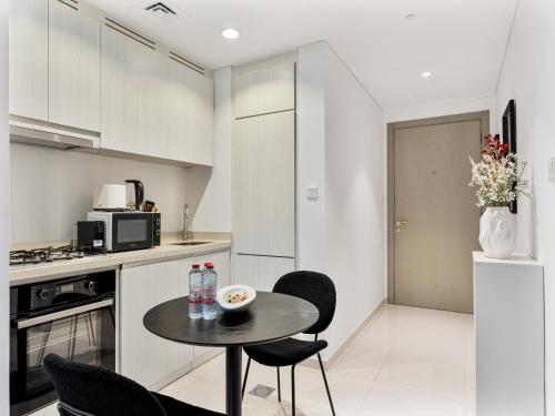 a kitchen with a small table and chairs in a room at Luxurious Escape - ZADA TOWER - Close to Dubai Mall & Burj Khalifa in Dubai