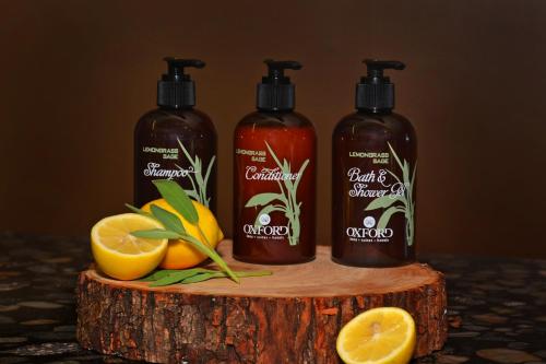 three bottles of shampoo and oranges on a tree stump at Oxford Suites Spokane Downtown in Spokane