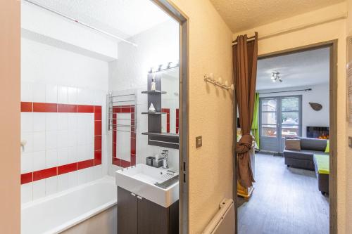 a bathroom with a sink and a bath tub at Appartement Terrasse Vue Montagne in Sainte-Marie-de-Campan