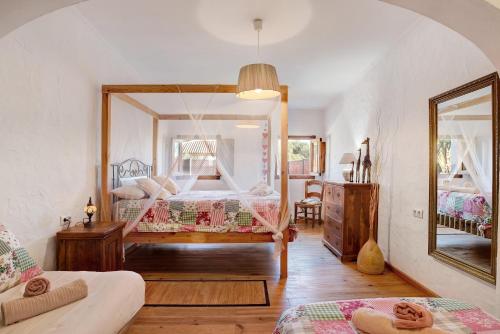 a bedroom with a bed and a large mirror at Casa Inma in Vejer de la Frontera