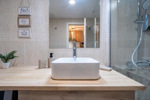 une salle de bain avec un lavabo blanc et une douche dans l'établissement Apartamentos Salou - 111, à Salou