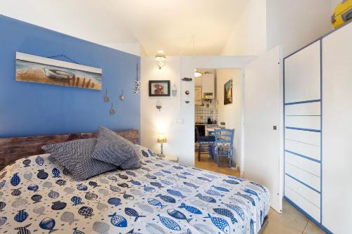 a bedroom with a bed with a blue wall at Attico con terrazza a Viareggio in Viareggio