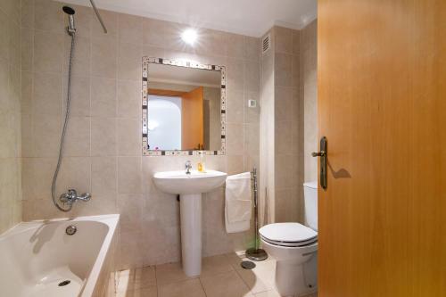 a bathroom with a sink toilet and a mirror at Algarve apartments H in Olhos de Água