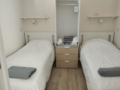 two beds in a small room with mirrors at Casa Camari in Policoro