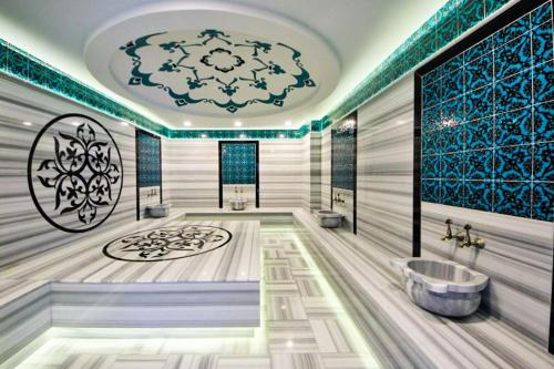 a bathroom with a tub and a sink at The Blue Tide - 1 Bedroom Apartment - All Bills Included in Alanya