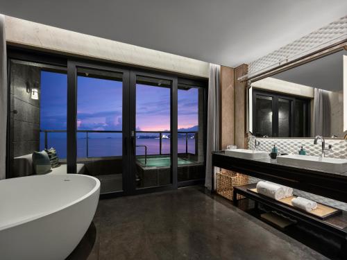 a bathroom with two sinks and a large window at 珠海凤凰湾悦榕庄 in Zhuhai