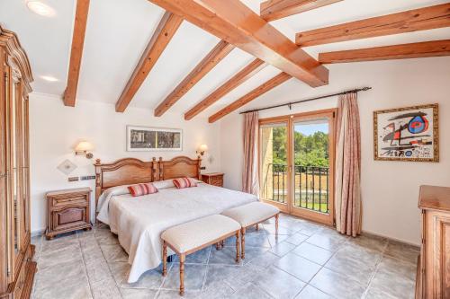 a bedroom with a bed and a balcony at Casa Del Pinaret in Port de Pollensa
