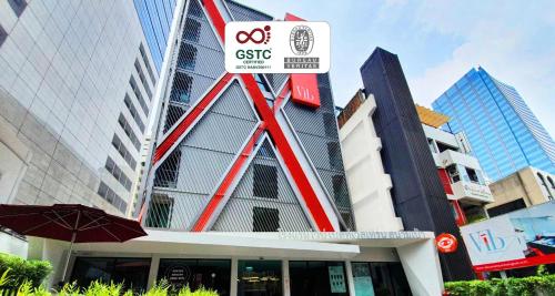 a building with a sign on the side of it at Vib Best Western Sanam Pao in Bangkok