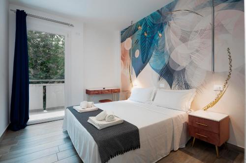 a bedroom with a bed and a painting on the wall at Evo Boutique Hotel & SPA in Bellaria-Igea Marina