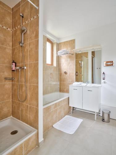 a bathroom with a shower and a tub and a sink at Residhome Paris Saclay " Bures sur Yvette " in Bures-sur-Yvette