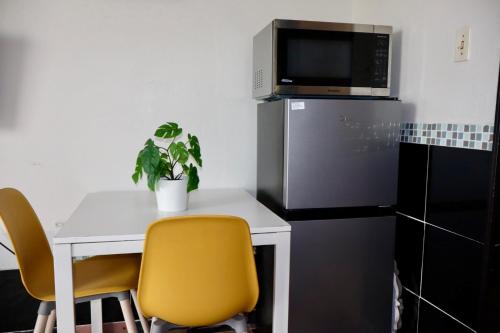 a small kitchen with a table and a microwave at Isla Verde Serenity by the Sea in San Juan
