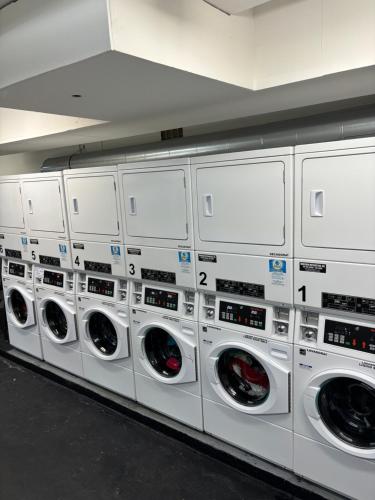 a row of white washing machines in a room at Isla Verde Serenity by the Sea in San Juan