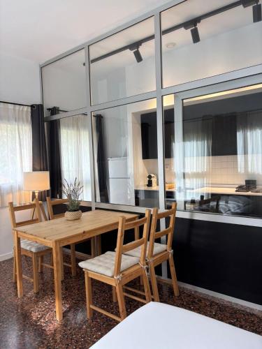 a dining room with a wooden table and chairs at Apartahotel Espai Verd Benimaclet in Valencia
