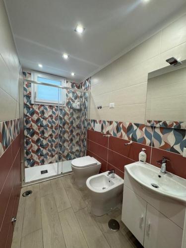 a bathroom with a toilet and a sink at AparthouseRisorgimento CANAPA in Frattamaggiore