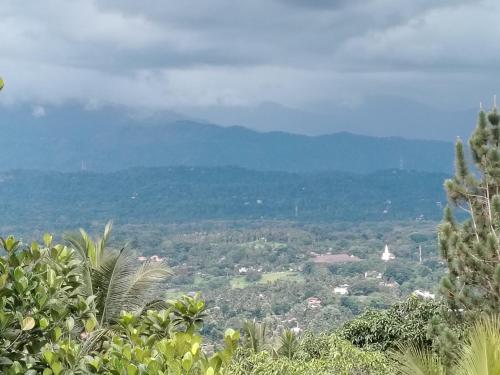 a view of a valley with mountains in the distance at Charlotte Inn in Kandy
