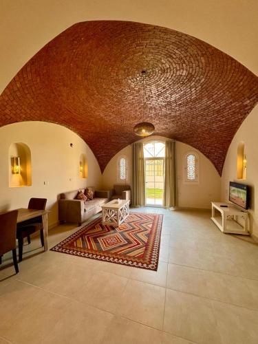 a large living room with a large brick ceiling at Royal Home Dome Style - Ground Floor Apartment in Jazīrat al ‘Awwāmīyah