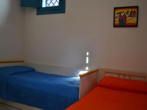 En eller flere senge i et værelse på Villetta climatizzata 5 posti-pt49