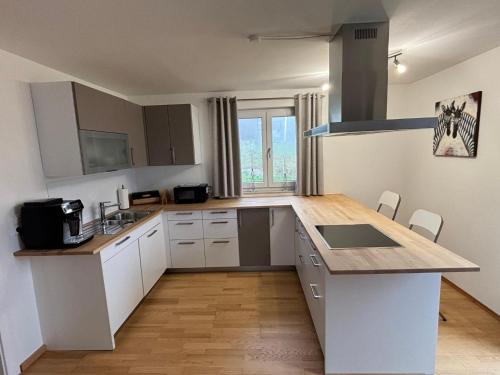 a kitchen with white cabinets and a counter top at Landhaus am Burgberg in Freyung