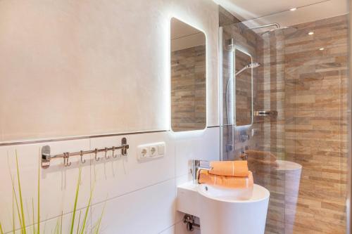 a bathroom with a white sink and a shower at Landhaus Lucia in Oberau