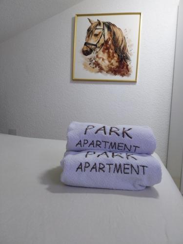a pile of towels on a table with a picture of a horse at Park Apartment in Kochani
