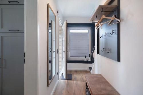 a hallway with a table and a mirror at Ferienhaus Anna Elbe in Wischhafen
