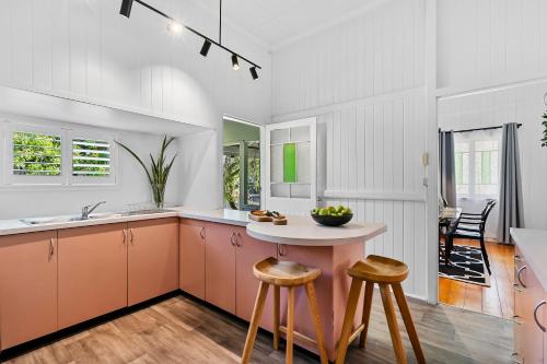 a kitchen with a table and two stools at Wandal Haven On McKelligett 3 Bedrooms - 1 King 2 Doubles - Wifi