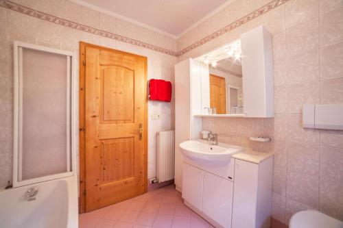 a bathroom with a sink and a toilet and a mirror at Sonnenparadies Apartement 3 in Saltusio