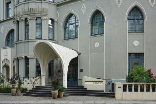 a large building with stairs and an entry way at Roomers Berlin Steinplatz, Autograph Collection in Berlin