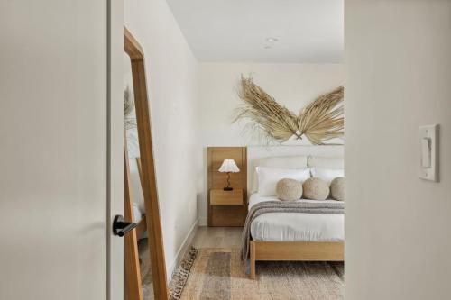 a bedroom with a bed and a mirror at Tide House - Unit A - Modern Seaside 1BD w Parking in El Segundo