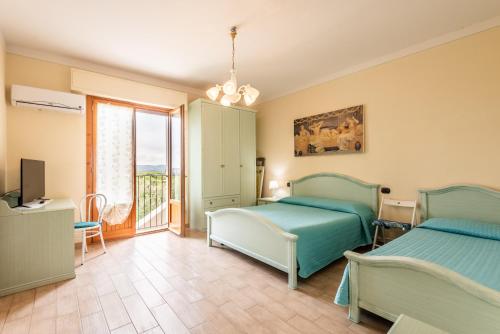 Un dormitorio con dos camas y un balcón. en Tenuta Fornacelle La Rosa, en San Gimignano