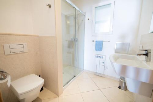 a bathroom with a toilet and a sink and a shower at Mestral in Port de Soller