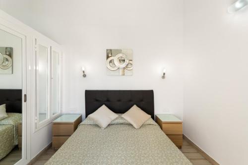 a bedroom with a bed and two night stands at Exclusive Sonemar in Maspalomas