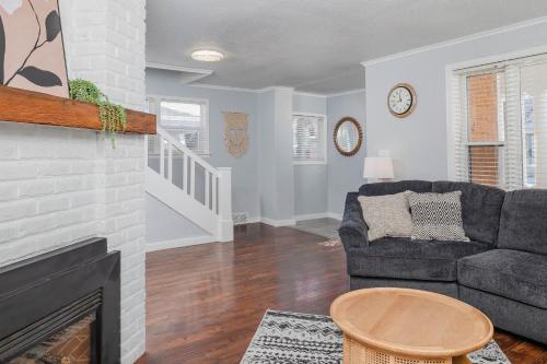 a living room with a couch and a fireplace at Bungalow on Baldwin - 3 bed 2 bath in Oshkosh