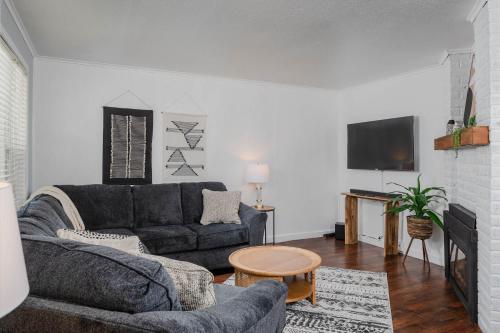 a living room with a couch and a tv at Bungalow on Baldwin - 3 bed 2 bath in Oshkosh