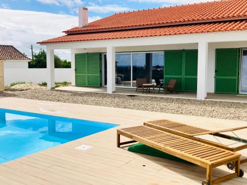 a villa with a swimming pool and a house at Casa Elo - Fresh-Built Home with Pool in Alcorochel