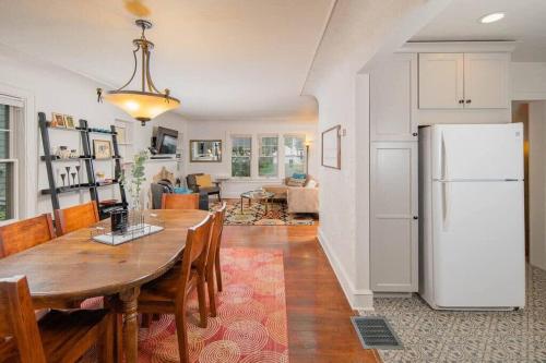 a kitchen with a dining table and a refrigerator at Family Brick House Charm - 4 br 3 bath in Appleton