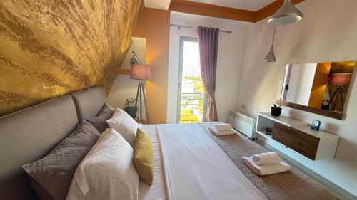 a bedroom with a bed with two towels on it at Your Apartment in Pogradec
