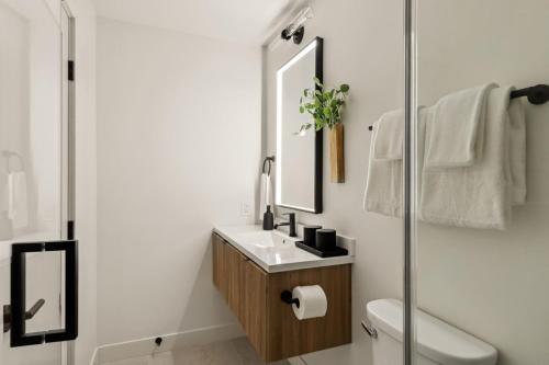 a bathroom with a sink and a mirror at Tide House - Unit B - Modern Seaside 1BD w Parking in El Segundo