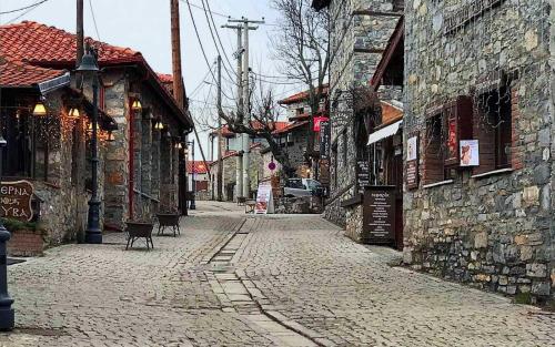 an empty cobblestone street in an old town at Villa Aretousa in Palaios Agios Athanasios