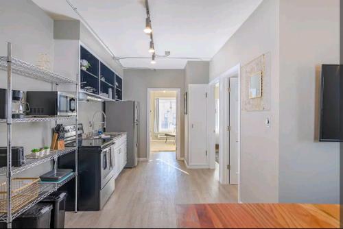 a large kitchen with black and white appliances at Downtown 2 Bedroom Apartment in Appleton