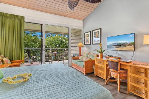 a bedroom with a bed and a desk with a desk at Napili Shores D227 · NS D227 OceanFront Resort w Pool in Kahana
